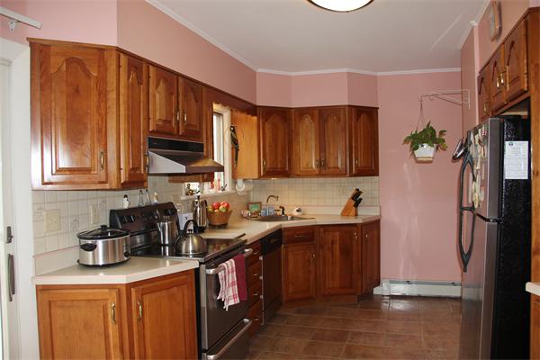 23 Marble Road Gloucester, MA 01930 - Photo 7 of 16 a kitchen with stainless steel appliances granite countertop a sink a stove and a refrigerator