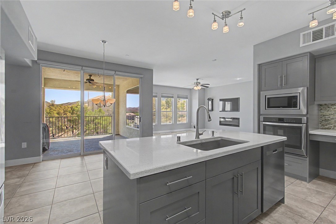 2555 Hampton Road, Unit 6308 Henderson, NV 89052 - Photo 8 of 30 View from contemporary kitchen through the sliding glass doors opening to a scenic balcony.