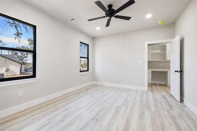 wooden floor in an empty room with a window