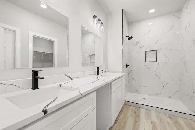 a bathroom with double vanity sink and a mirror
