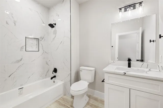 a bathroom with a sink a toilet and a bathtub