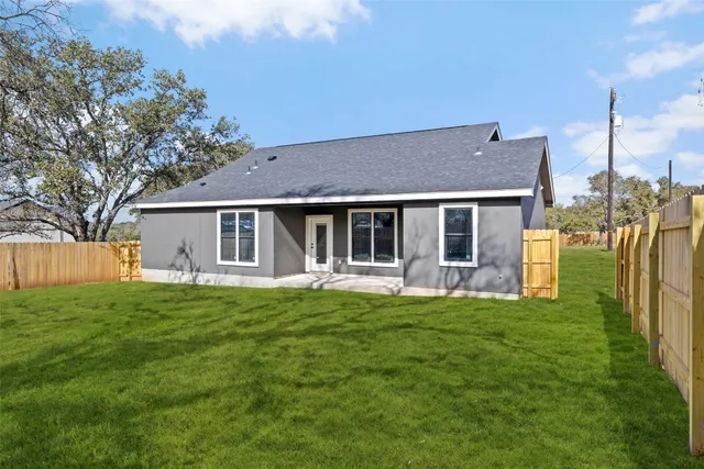 a front view of a house with a garden and porch