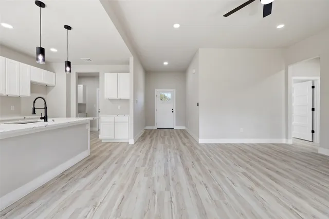 a view of a kitchen with a sink and wooden floor