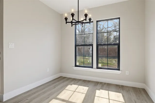 an empty room with windows and entrance