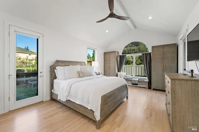 a spacious bedroom with a large bed and a large window