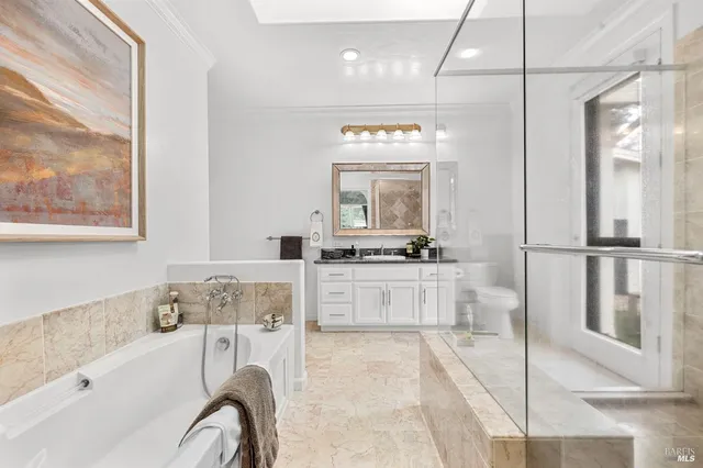 a bathroom with a tub sink and mirror