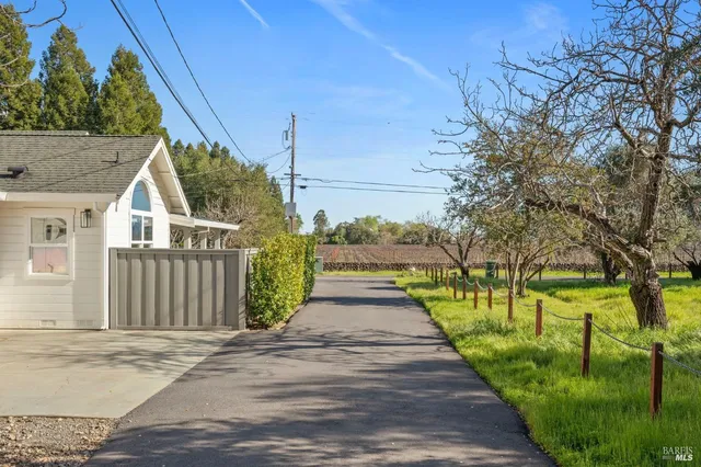 a view of a pathway of a house with a yard