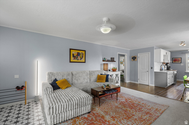 961 33rd Street Ogden, UT 84403 - Photo 10 of 39 Living area featuring light blue walls and a white ceiling with a ceiling fan