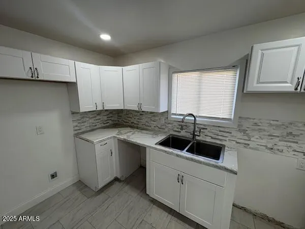 a kitchen with a sink and cabinets