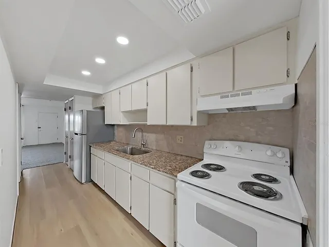 a kitchen that has a cabinets and a stove