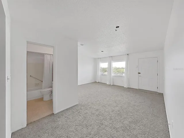 a view of an empty room with a window