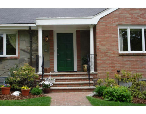 25 Mignon Road Newton, MA 02465 - Photo 2 of 22 a view of a house with potted plants and a bench