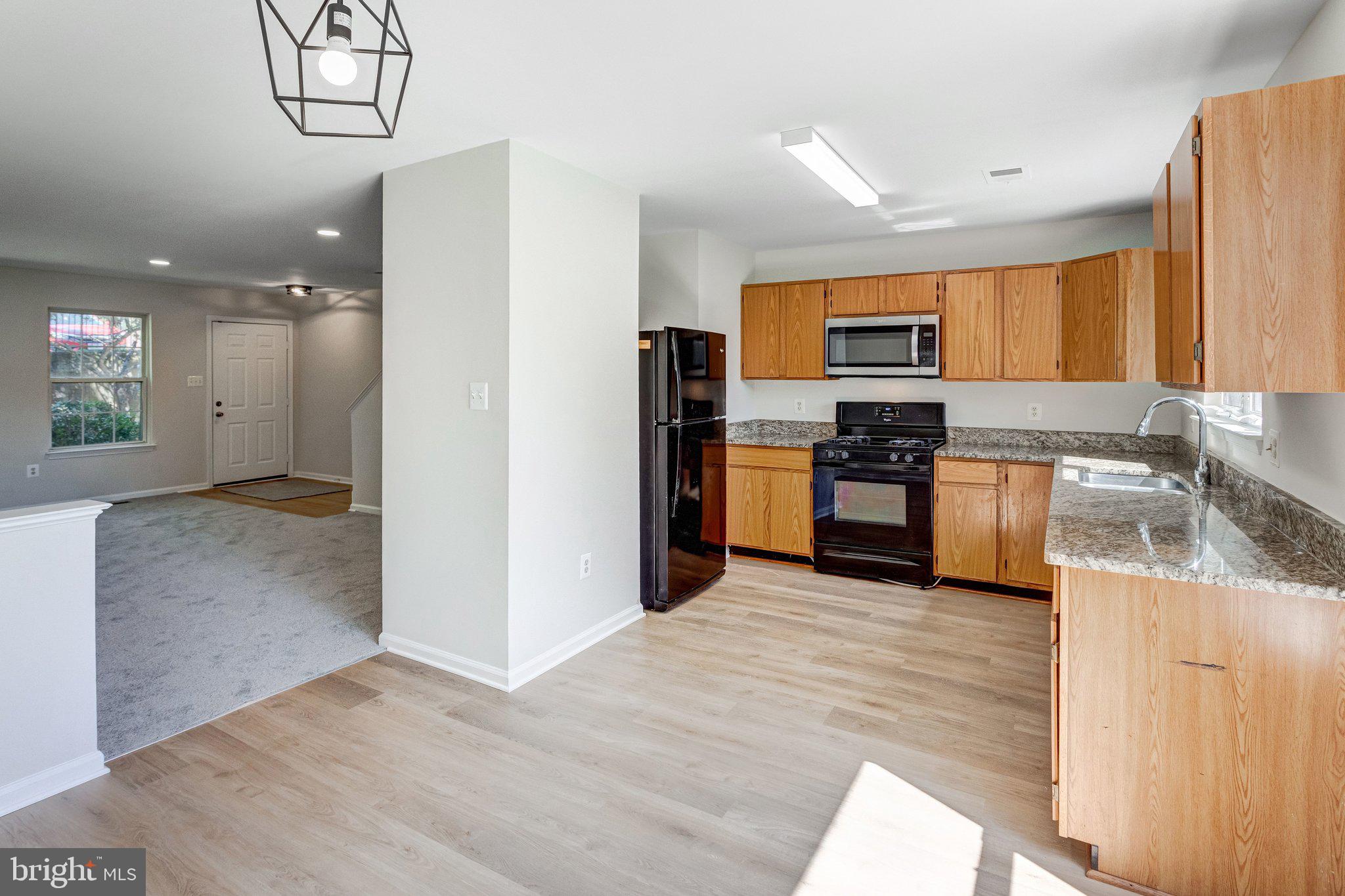 6489 McCoy Road Centreville, VA 20121 - Photo 9 of 34 Modern kitchen with warm wood tones.