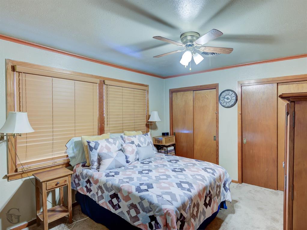 5909 Yarbrough Road Shreveport, LA 71119 - Photo 19 of 19 a bedroom with a bed and a chandelier