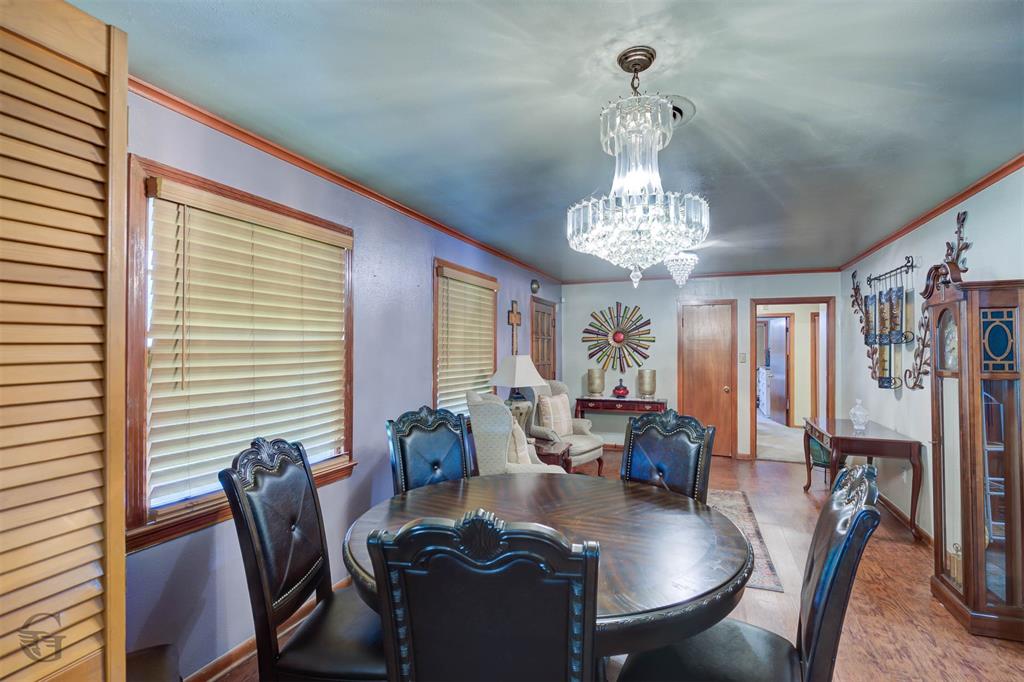 5909 Yarbrough Road Shreveport, LA 71119 - Photo 10 of 19 a dining room with furniture a chandelier and wooden floor
