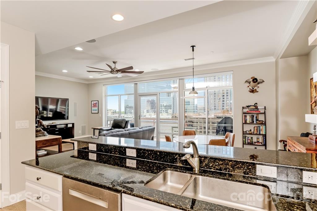 a large kitchen with kitchen island granite countertop a large window and a counter space