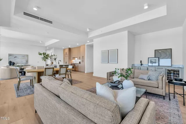 a dining room with furniture and a rug