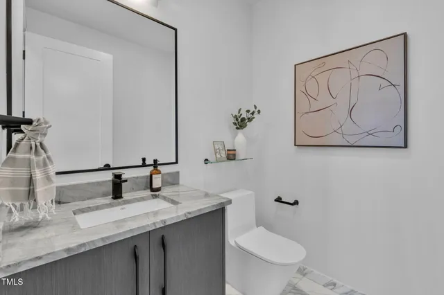 a bedroom with a bed and a lamp with wooden floor