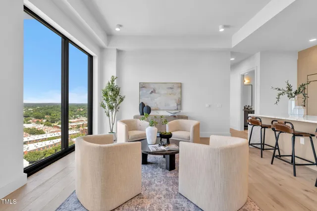 a large kitchen with stainless steel appliances a large counter top and a wooden floor