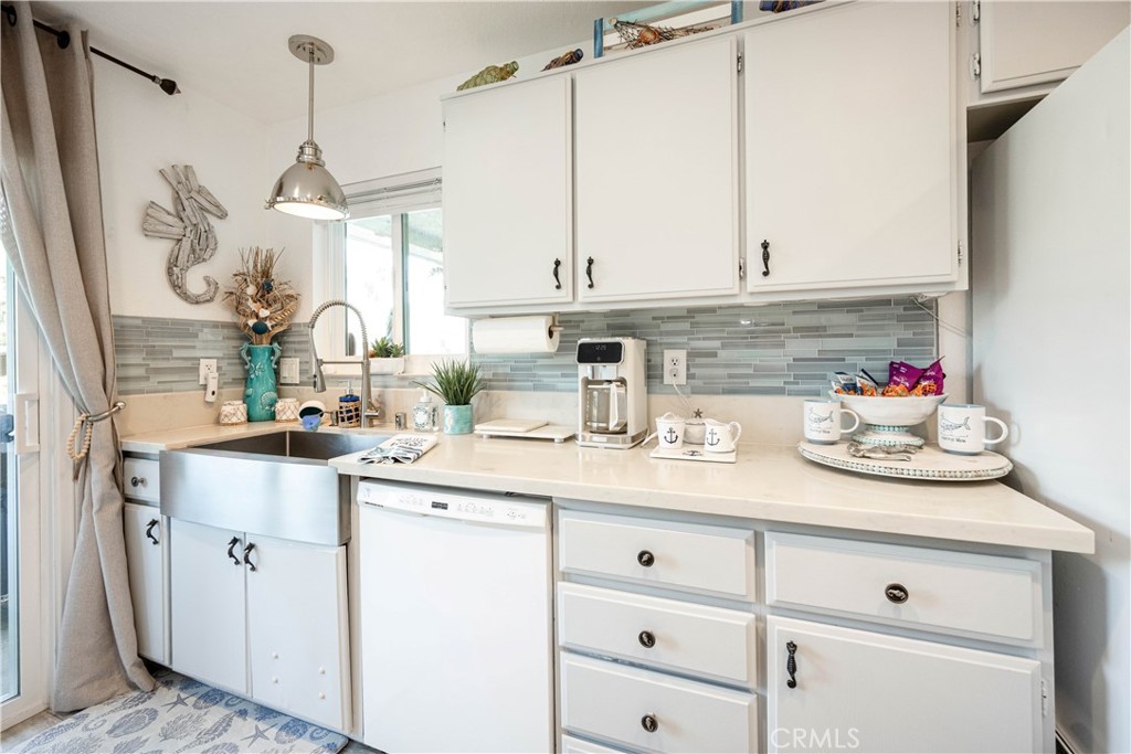 68 Corniche Drive, Unit B Dana Point, CA 92629 - Photo 13 of 35 a kitchen with cabinets appliances a sink and a counter top space