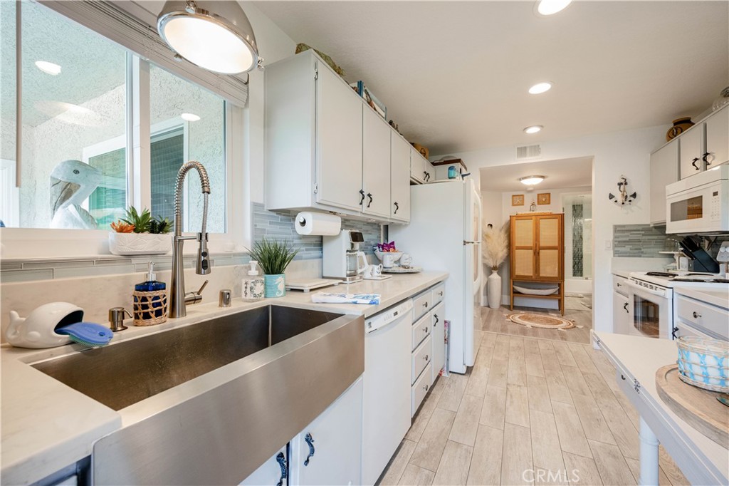 68 Corniche Drive, Unit B Dana Point, CA 92629 - Photo 16 of 35 a kitchen with stainless steel appliances granite countertop a sink dishwasher stove and refrigerator