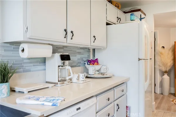 a kitchen with a refrigerator and cabinets