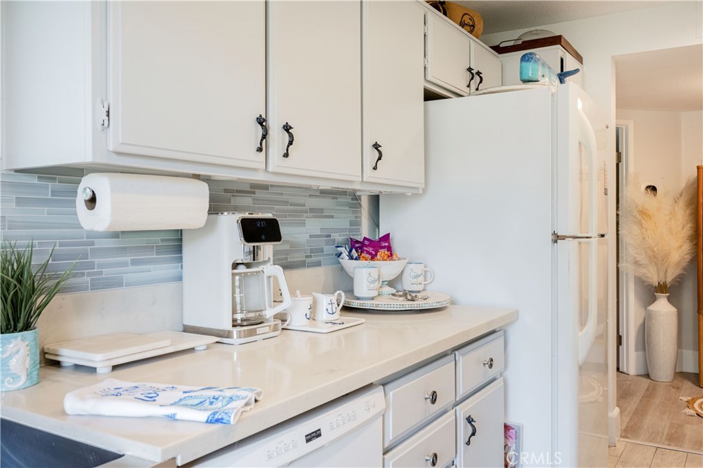 68 Corniche Drive, Unit B Dana Point, CA 92629 - Photo 18 of 35 a kitchen with a refrigerator and cabinets