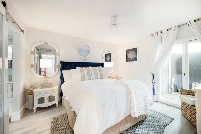 a bedroom with bed and wooden floor