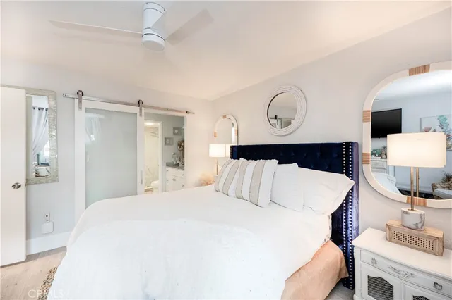 a bedroom with a bed and a table with the bathroom