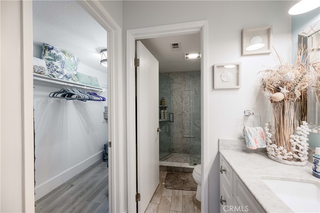 68 Corniche Drive, Unit B Dana Point, CA 92629 - Photo 23 of 35 a bathroom with a granite countertop sink a mirror and a shower