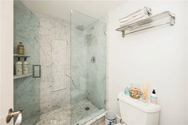 a bathroom with a shower a toilet and a sink