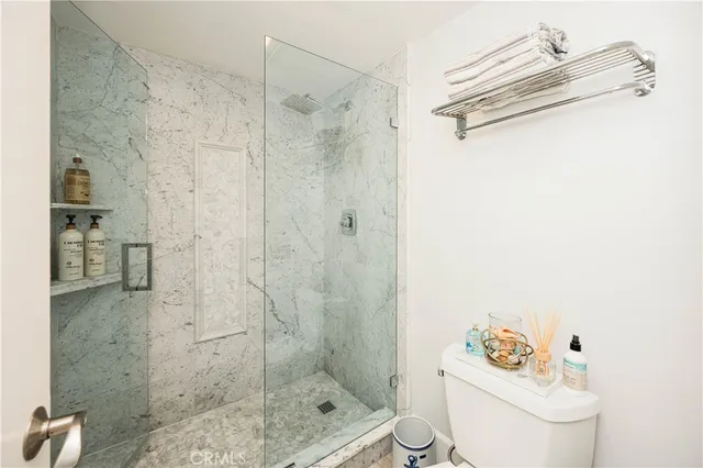 a bathroom with a shower a toilet and a sink