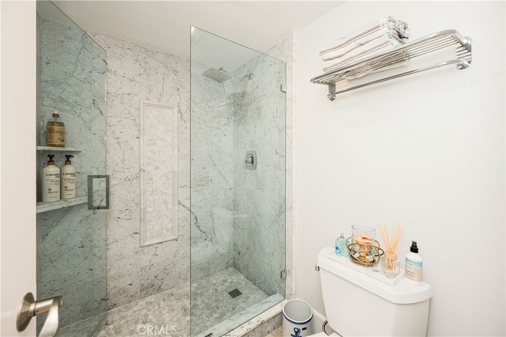 68 Corniche Drive, Unit B Dana Point, CA 92629 - Photo 25 of 35 a bathroom with a shower a toilet and a sink