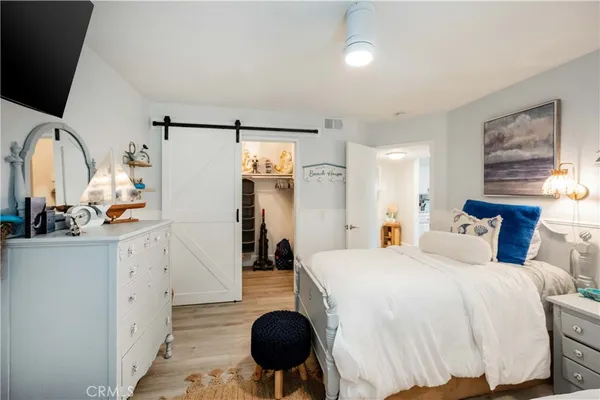 a spacious bedroom with a bed and a large mirror