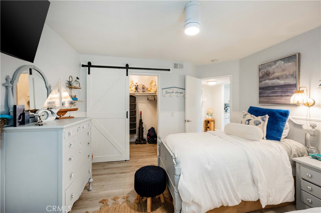 68 Corniche Drive, Unit B Dana Point, CA 92629 - Photo 28 of 35 a spacious bedroom with a bed and a large mirror