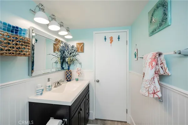 a bathroom with a sink vanity and a mirror