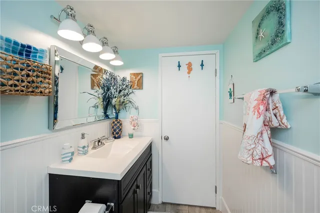 a bathroom with a sink vanity and a mirror