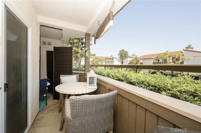 a dining room with furniture and a floor to ceiling window