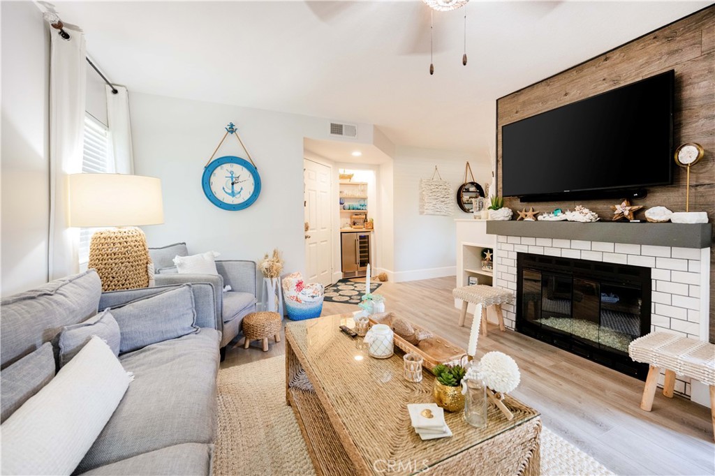 68 Corniche Drive, Unit B Dana Point, CA 92629 - Photo 4 of 35 a living room with furniture a flat screen tv and a fireplace