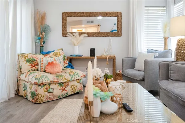 a living room with furniture and a mirror