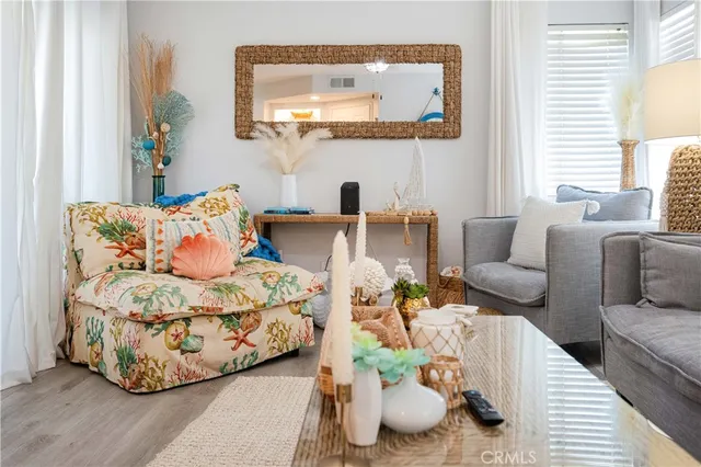 a living room with furniture and a mirror