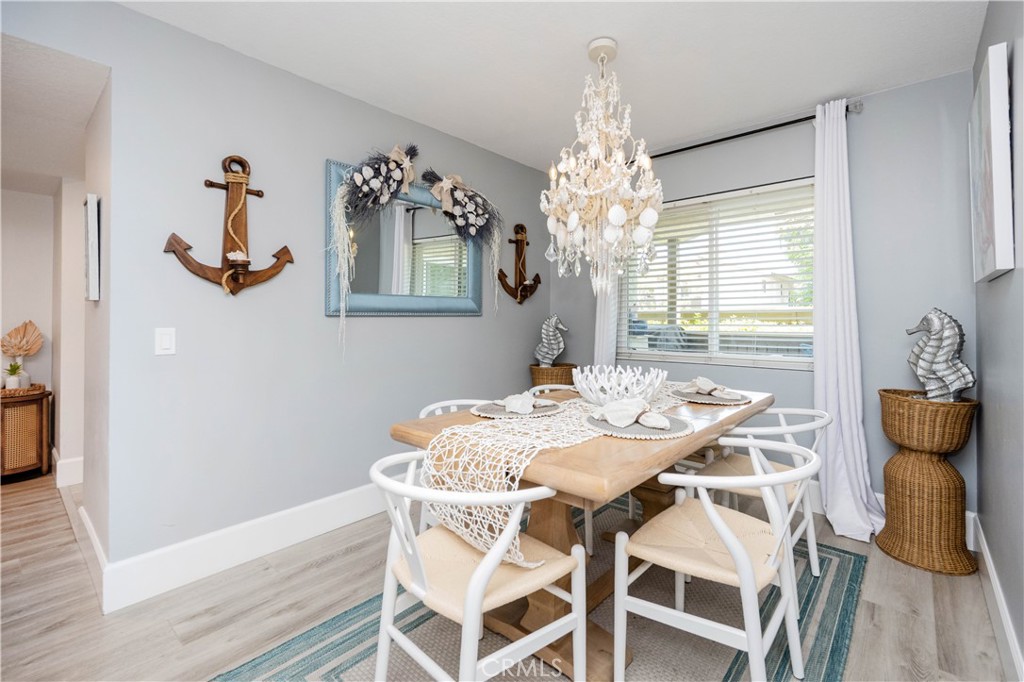 68 Corniche Drive, Unit B Dana Point, CA 92629 - Photo 9 of 35 a view of a dining room with furniture and wooden floor