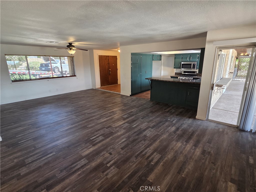 19145 Tomahawk Road Apple Valley, CA 92307 - Photo 11 of 38 a view of kitchen and hall with wooden floor
