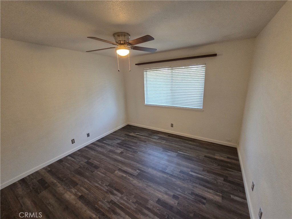 19145 Tomahawk Road Apple Valley, CA 92307 - Photo 17 of 38 en empty room with wooden floor and windows