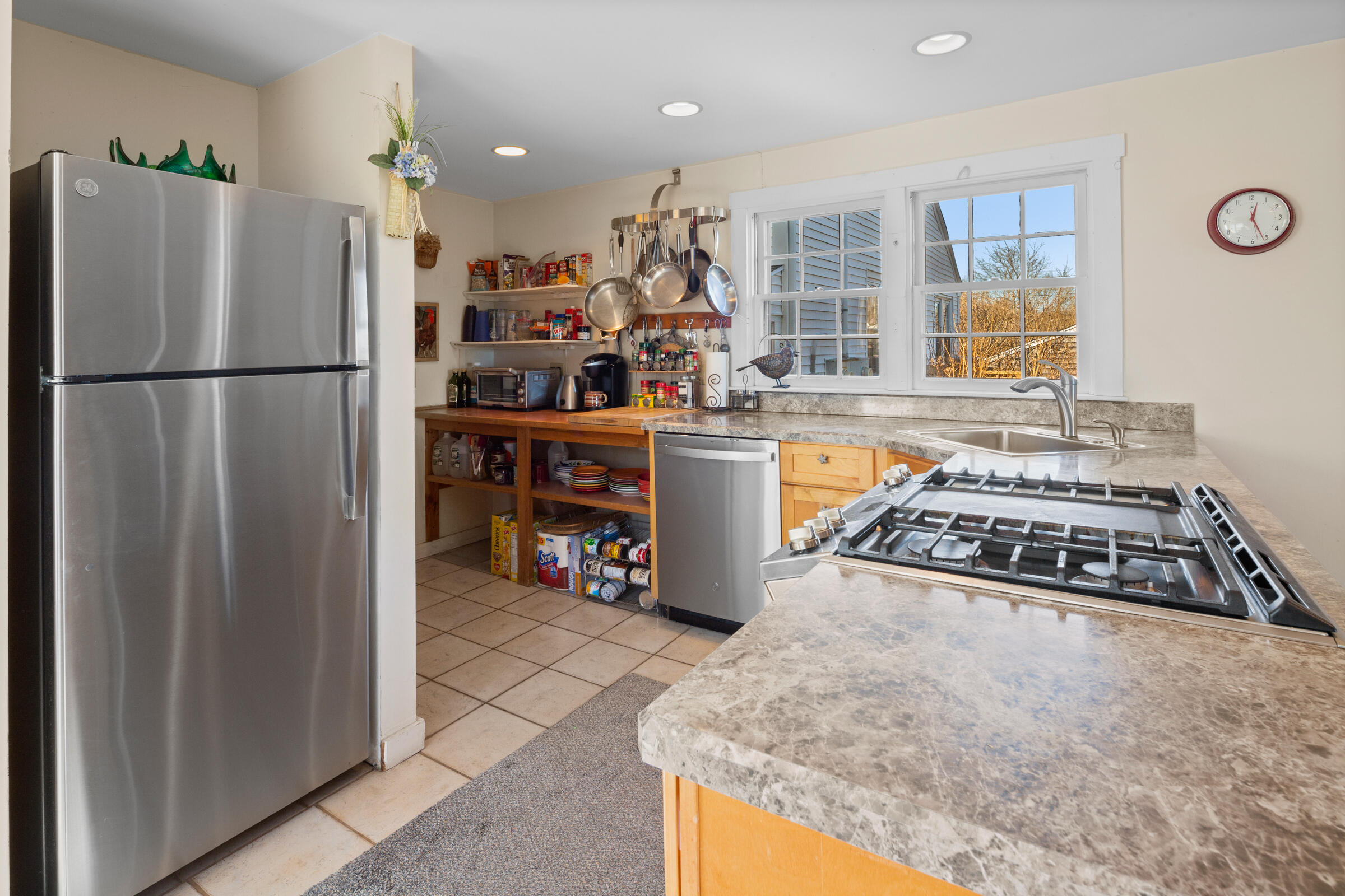 115 Commercial Street, Unit B Wellfleet, MA 02667 - Photo 12 of 37 a kitchen with stainless steel appliances granite countertop a refrigerator a stove and a sink
