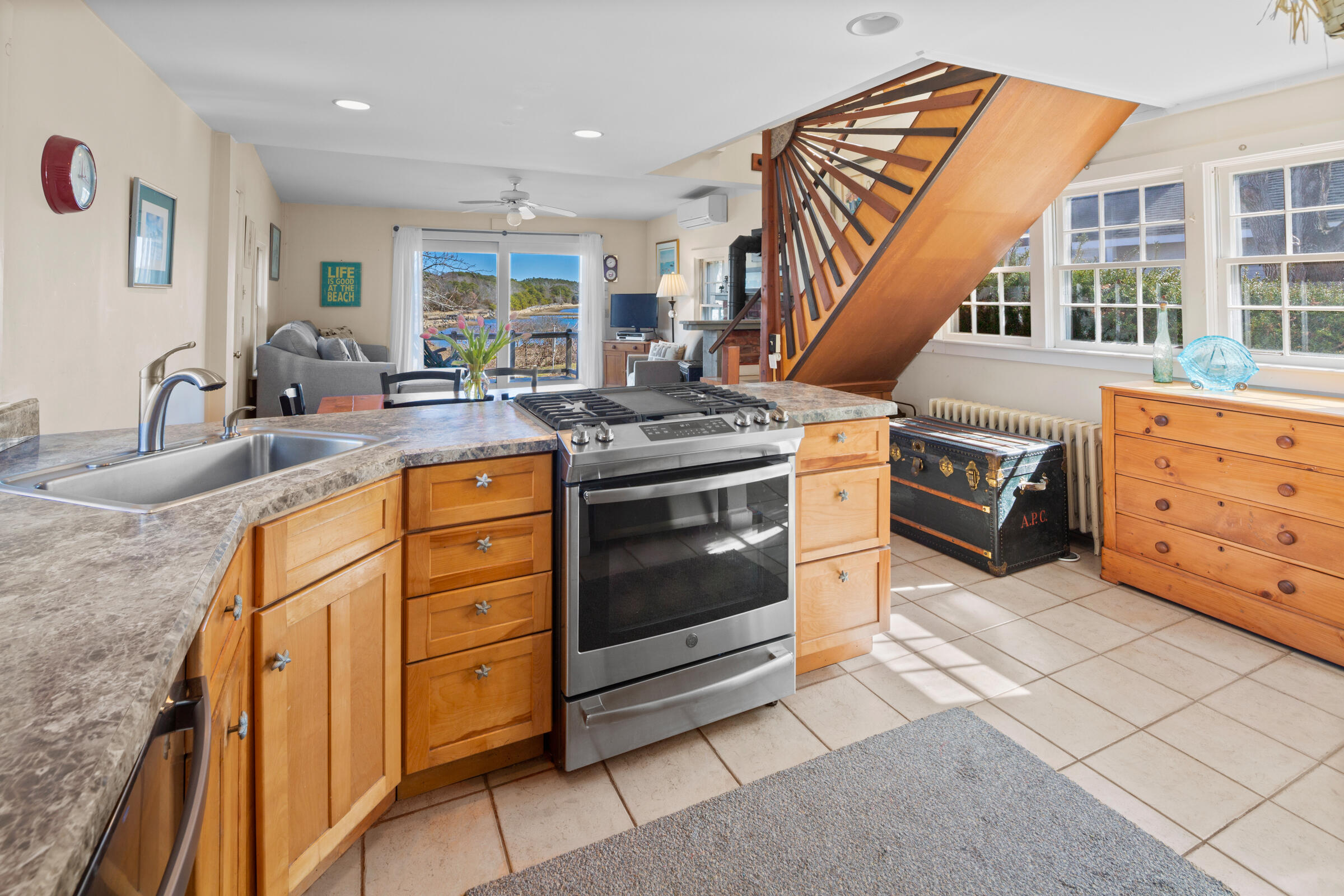 115 Commercial Street, Unit B Wellfleet, MA 02667 - Photo 14 of 37 a kitchen with stainless steel appliances granite countertop a stove and a sink