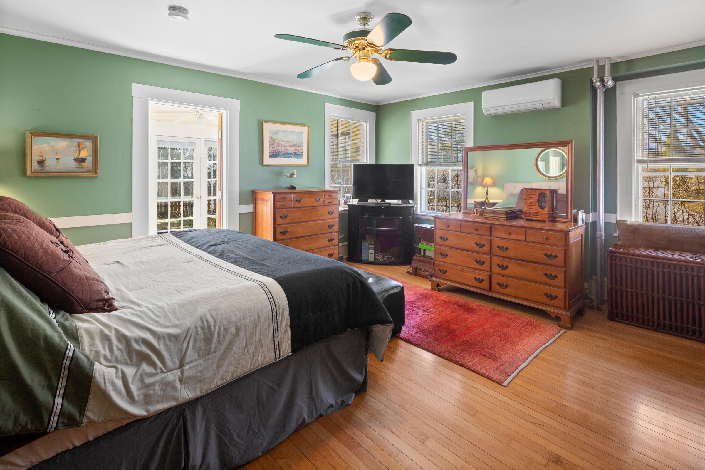115 Commercial Street, Unit B Wellfleet, MA 02667 - Photo 17 of 37 a bedroom with a bed and wooden floor