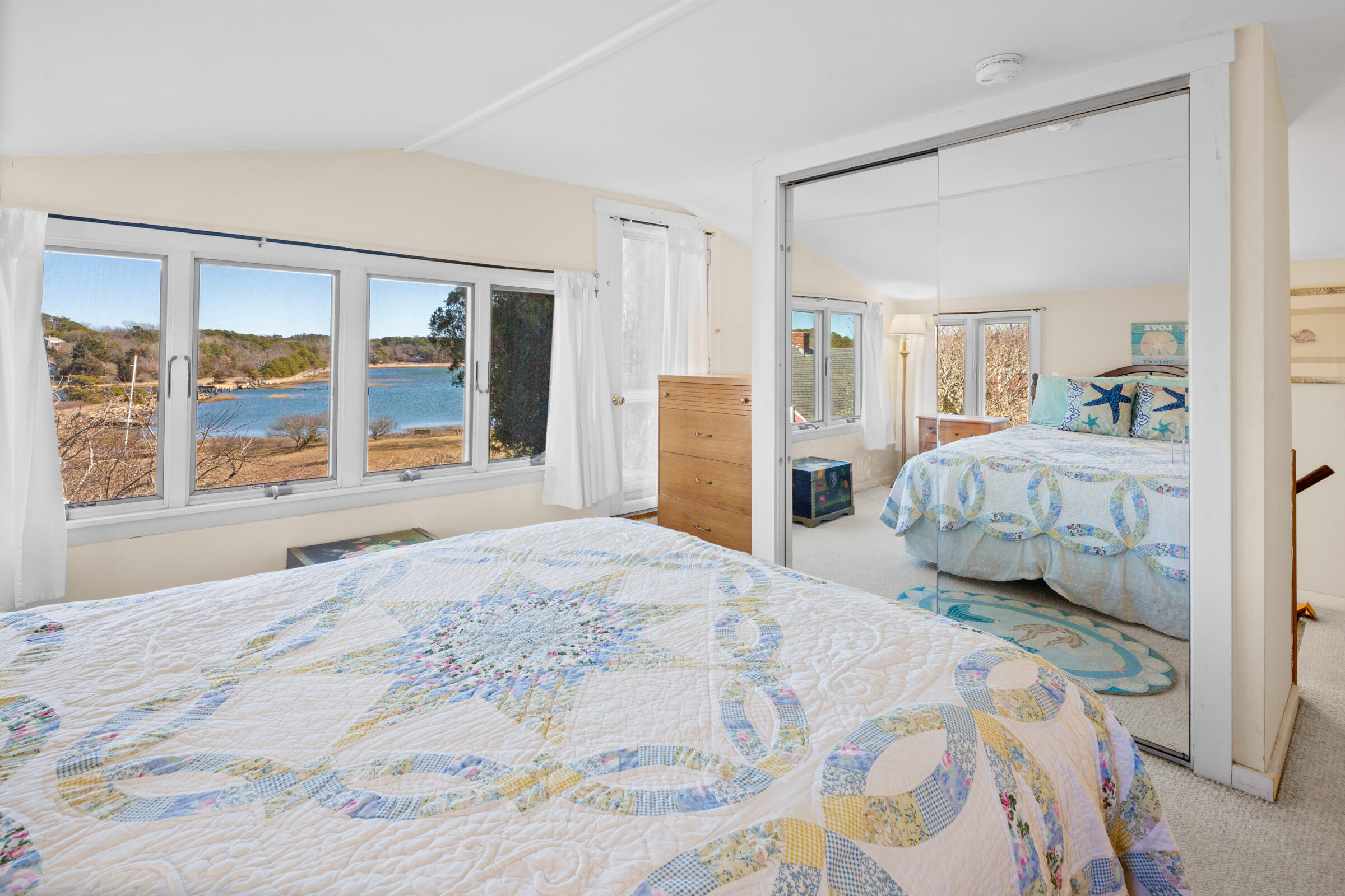 115 Commercial Street, Unit B Wellfleet, MA 02667 - Photo 24 of 37 a bedroom with a large bed and a large window