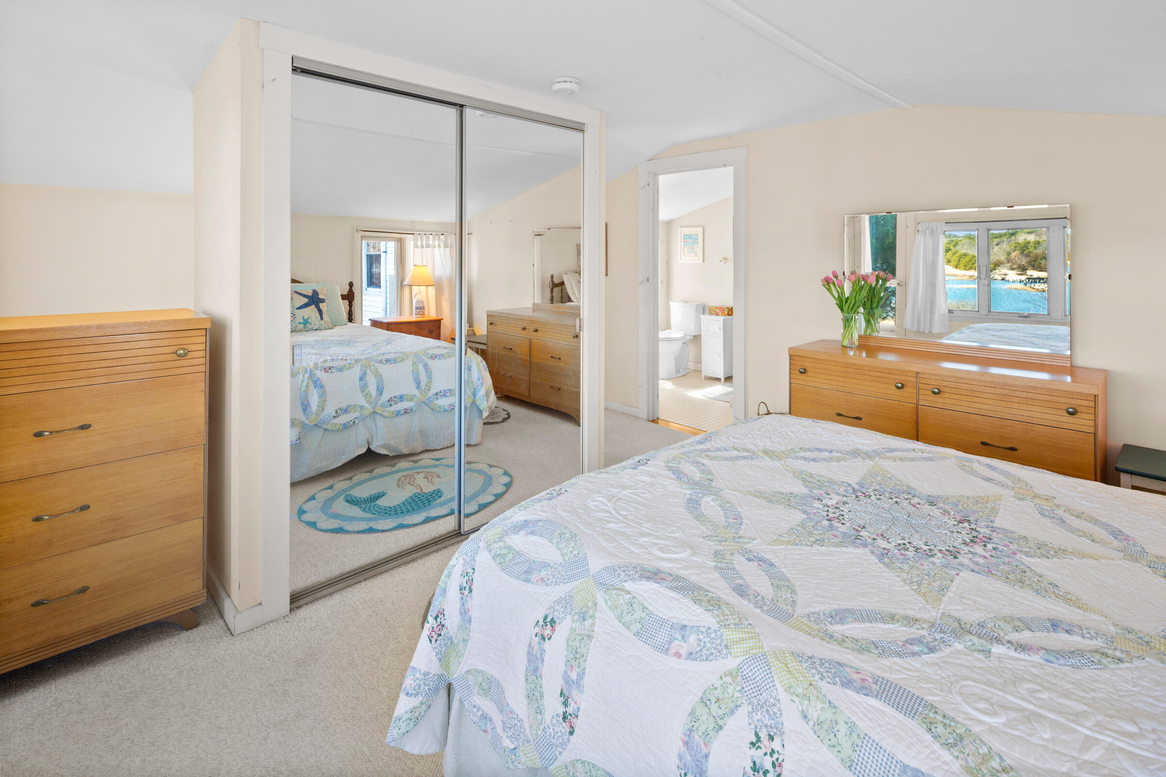 115 Commercial Street, Unit B Wellfleet, MA 02667 - Photo 25 of 37 a bedroom with a bed and a dresser