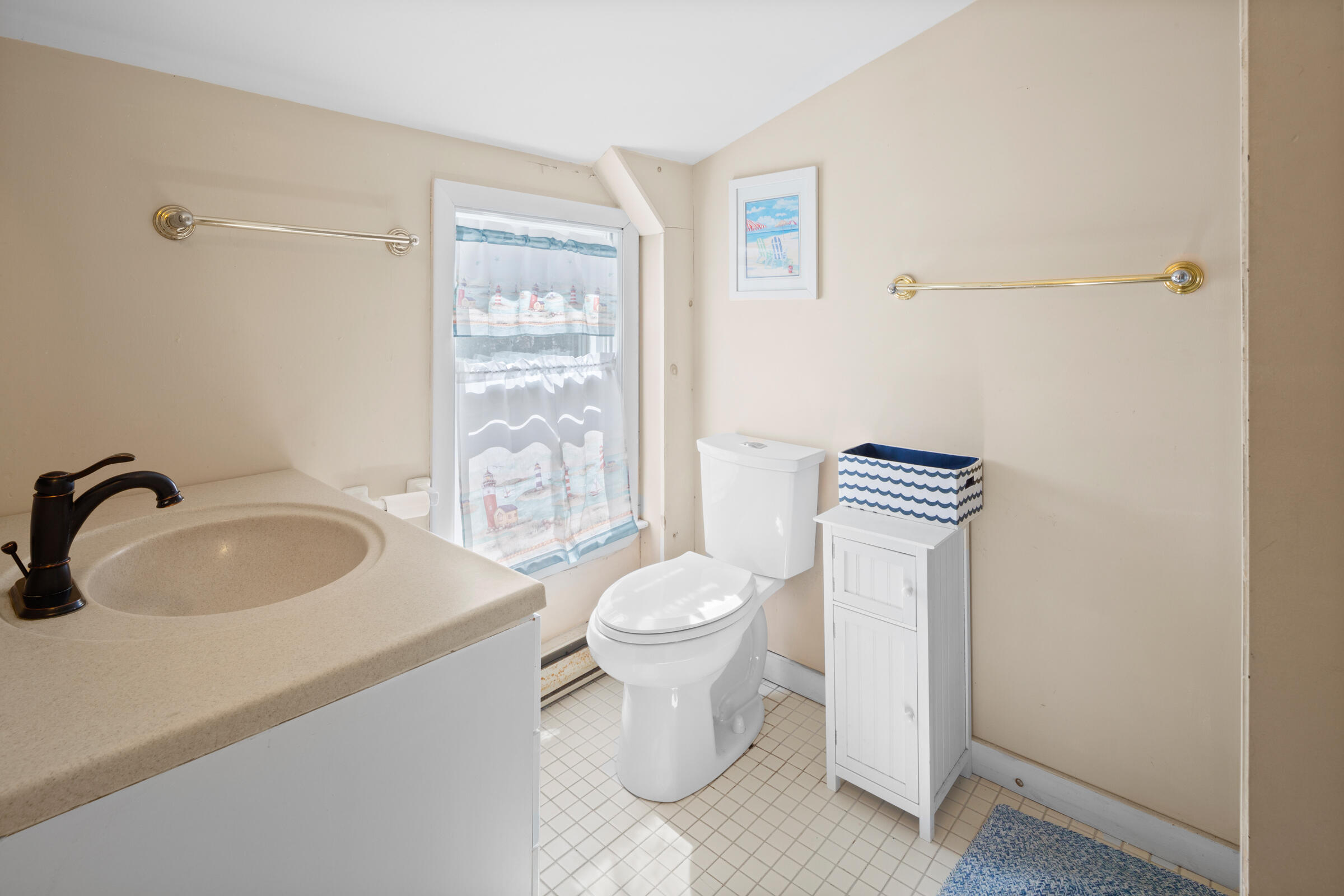 115 Commercial Street, Unit B Wellfleet, MA 02667 - Photo 26 of 37 a bathroom with a sink toilet and a mirror